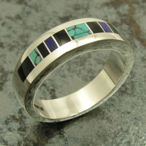 Sterling silver ring inlaid with spiderweb turquoise, black onyx and lapis.